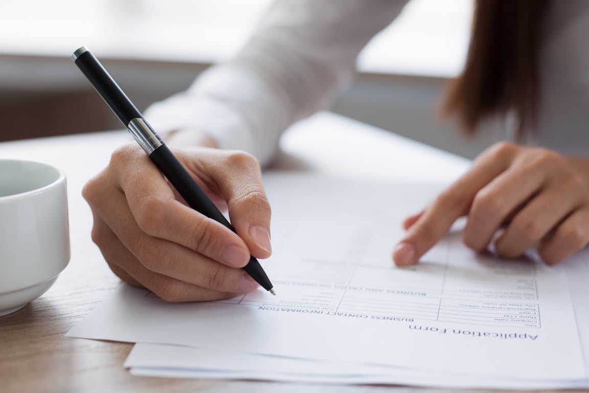 Closeup of Woman Completing Application Form